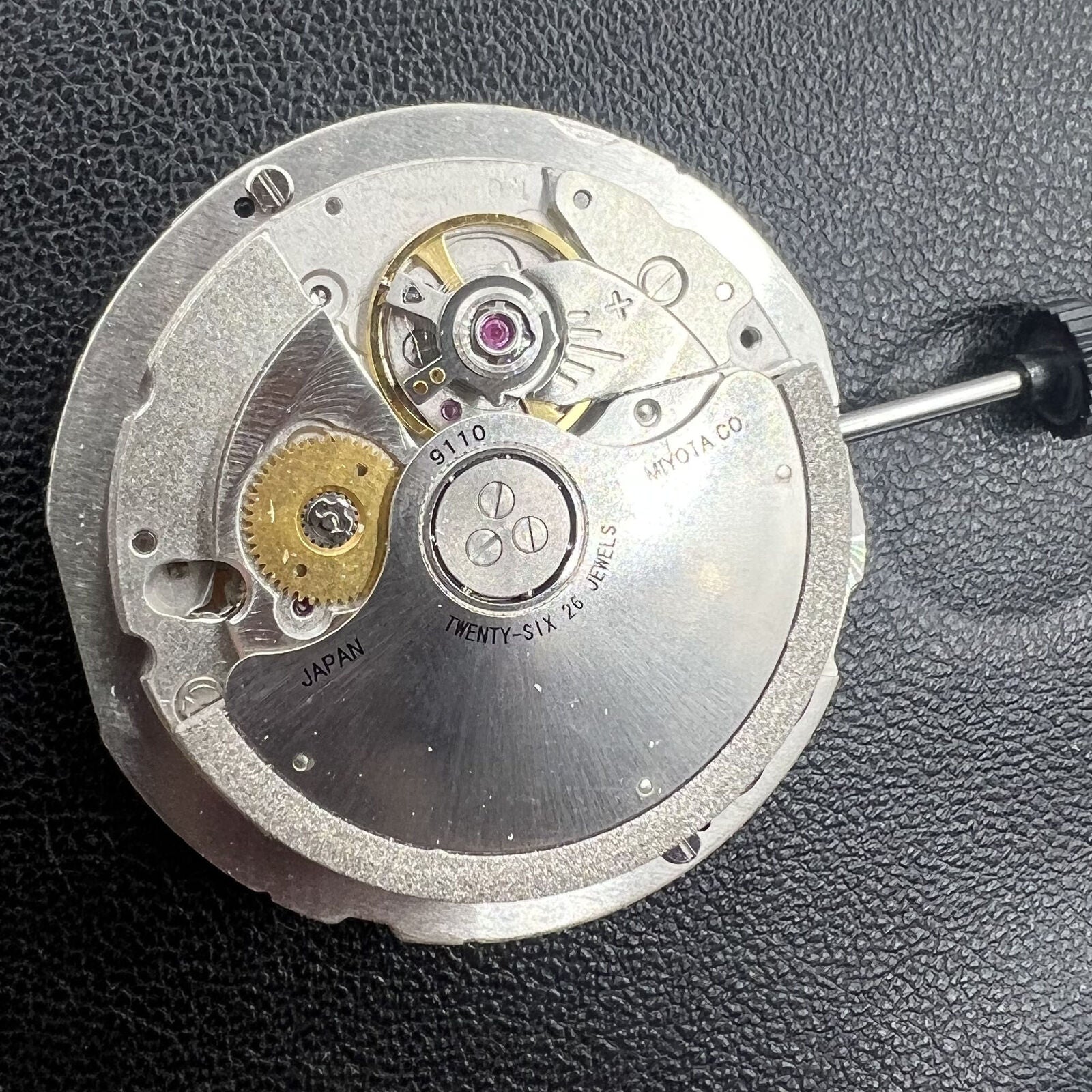 Miyota 9110 automatic watch movement showing date display at 3 o'clock, precision-engineered for accuracy.