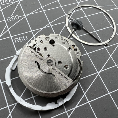 Miyota/Citizen 8215 automatic watch movement with black dial and date at 6, Japan-made precision.