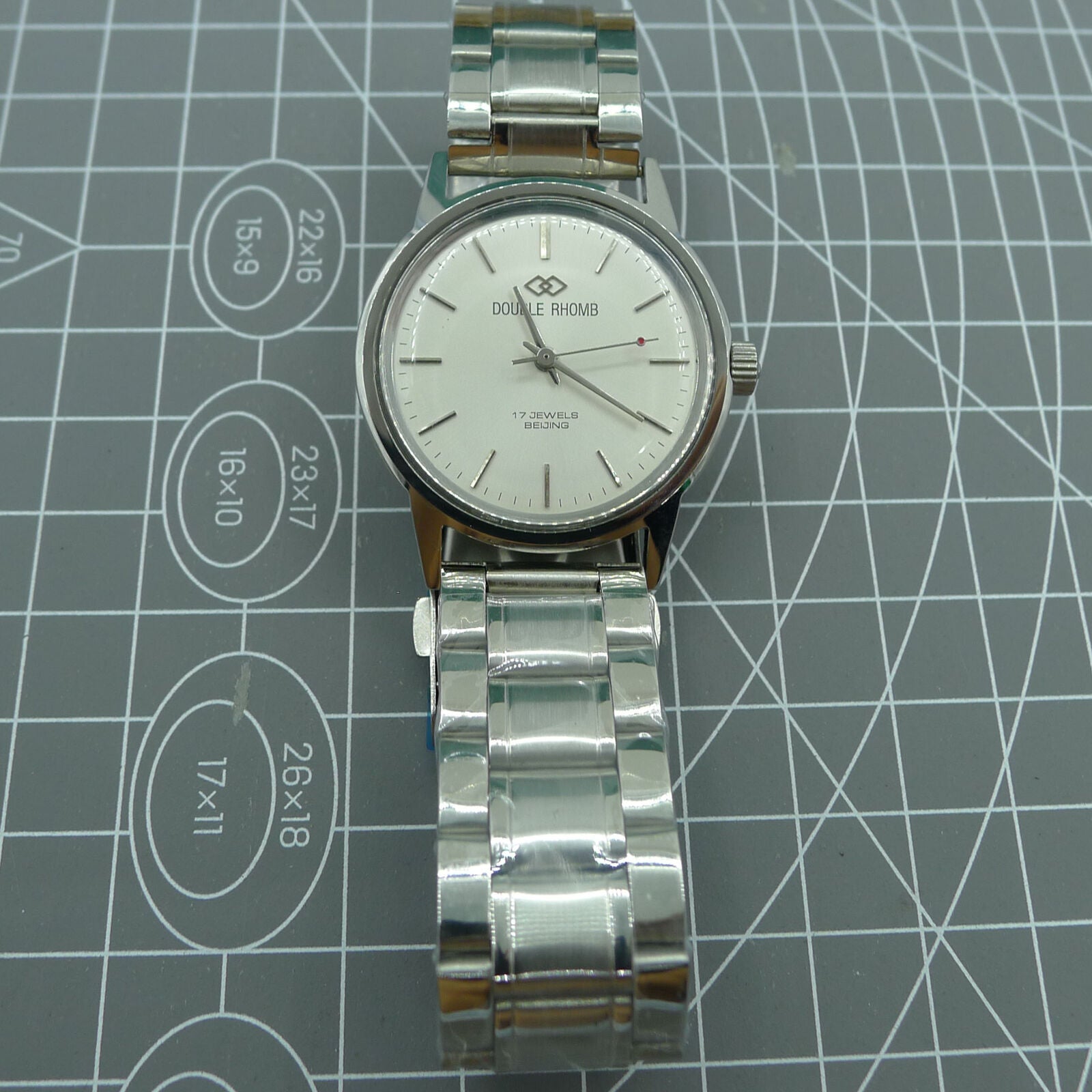 Beijing 36mm manual mechanical watch with silver case and nail-shaped markers, classic design accessory.