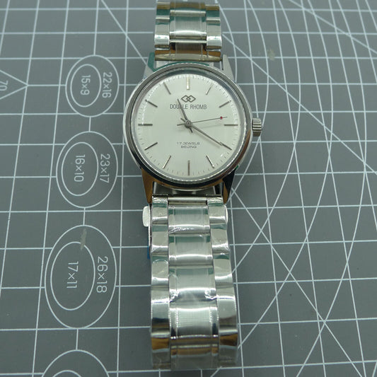 Beijing 36mm manual mechanical watch with silver case and nail-shaped markers, classic design accessory.