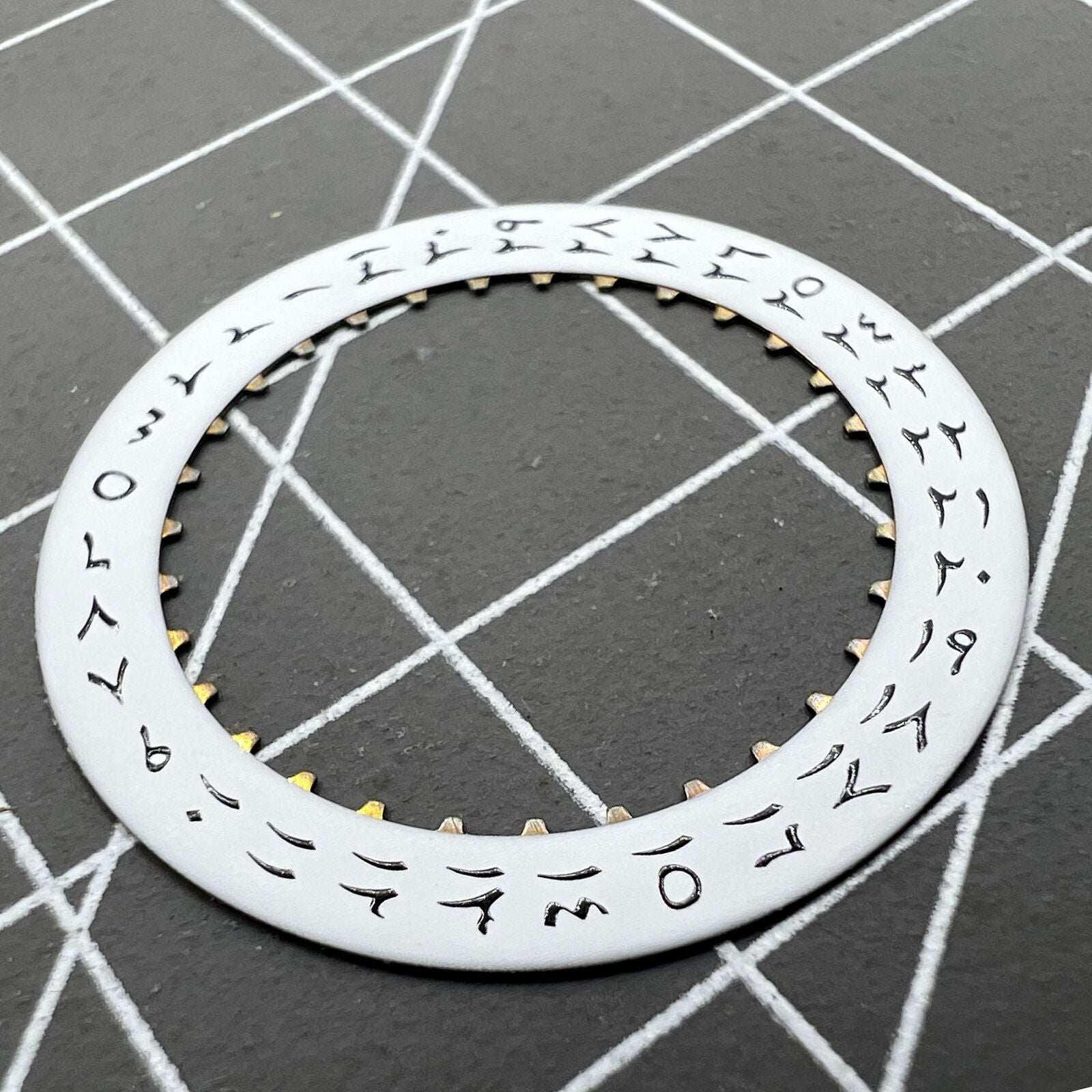 White background close-up of Arabic date disk wheel for ETA2824 Datejust watches, precision component.
