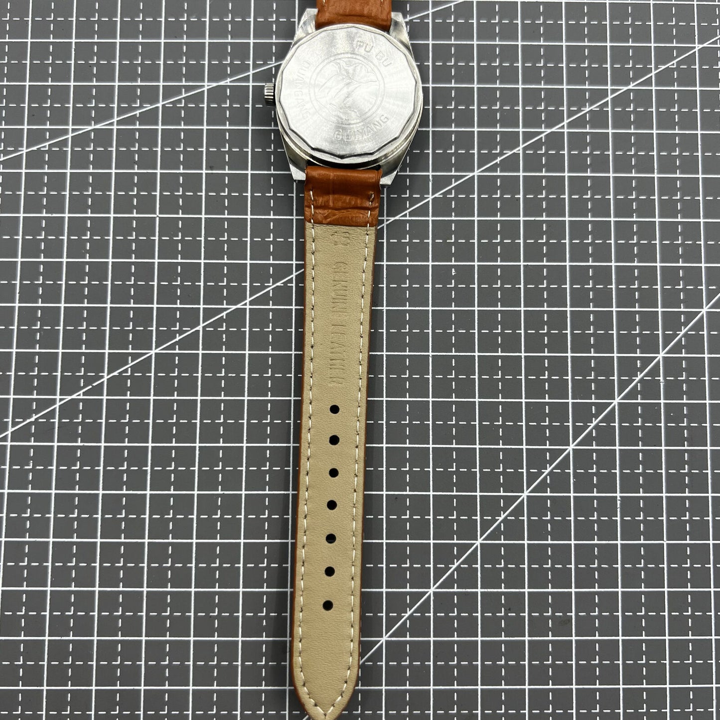 PUBU 32mm manual mechanical watch with grey dial and nail markers, showcasing 17 jewels and precise craftsmanship.