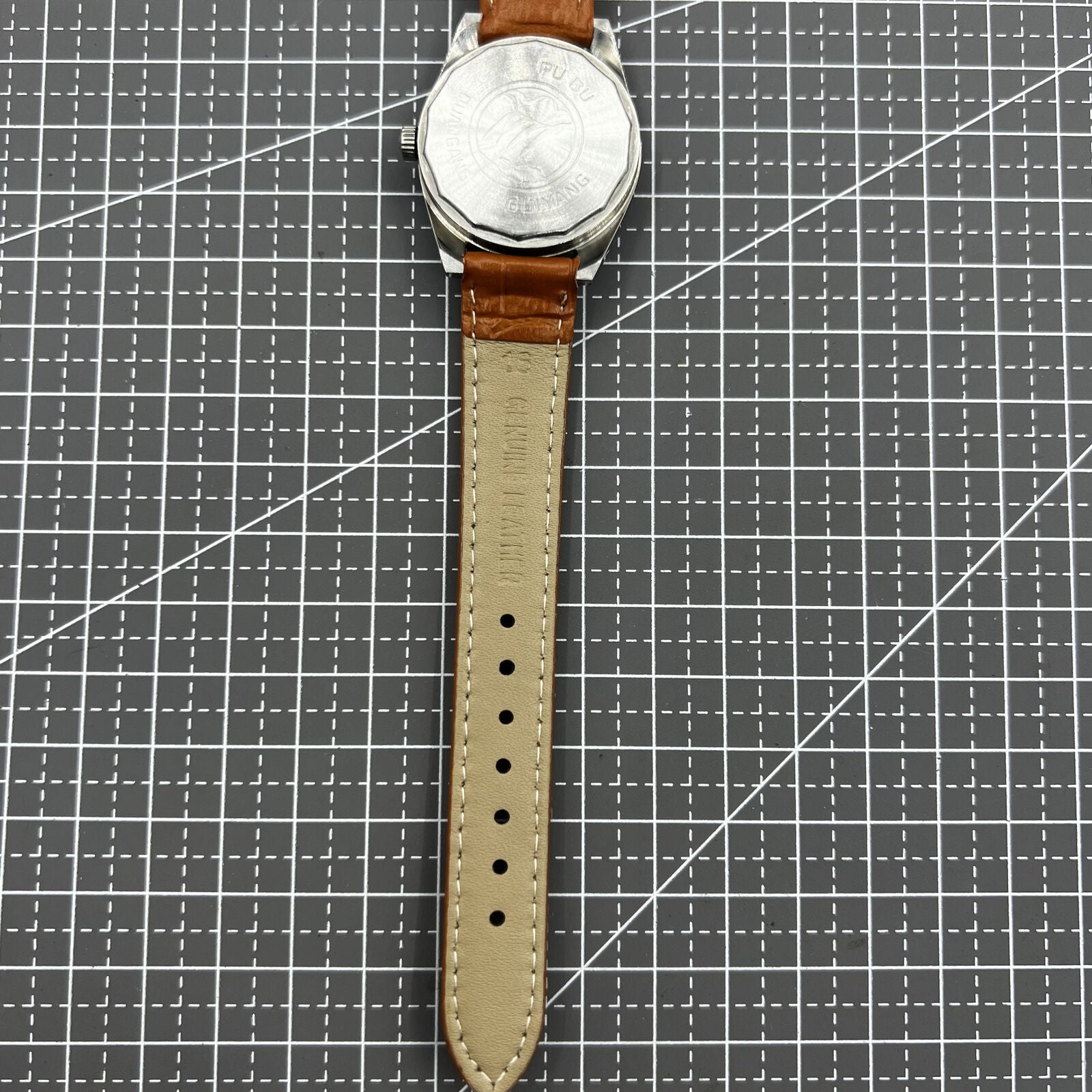 PUBU 32mm manual mechanical watch with grey dial and nail markers, showcasing 17 jewels and precise craftsmanship.