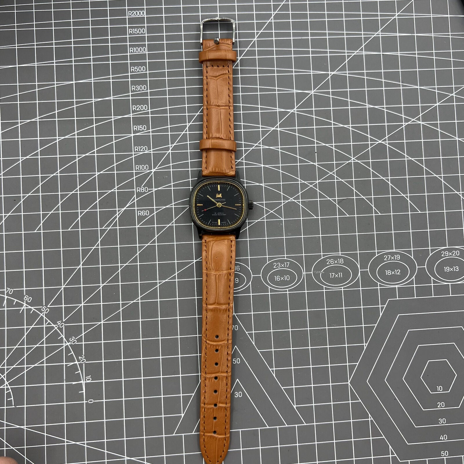 34mm Shanghai Factory manual mechanical watch with black dial, 19 jewels, shock-resistant design.