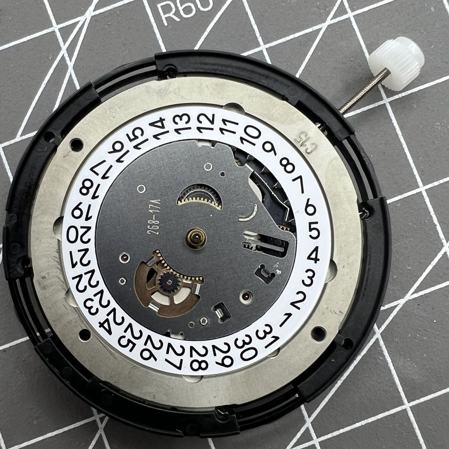 Swiss Made ETA C15.111 chronograph watch movement by Tissot with white dial for precise timekeeping.