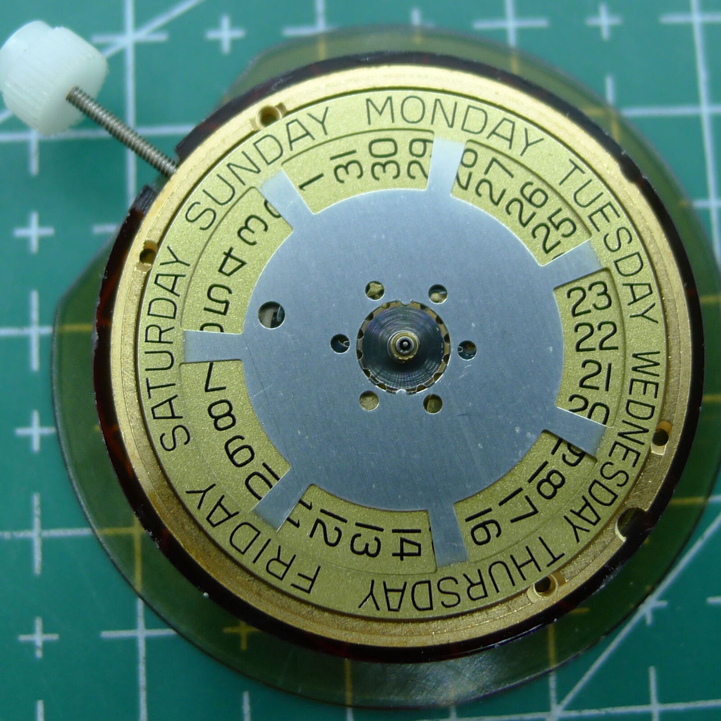 Swiss Made ETA 955.132 quartz watch movement displaying double calendar with week at 12 and date at 3 features.
