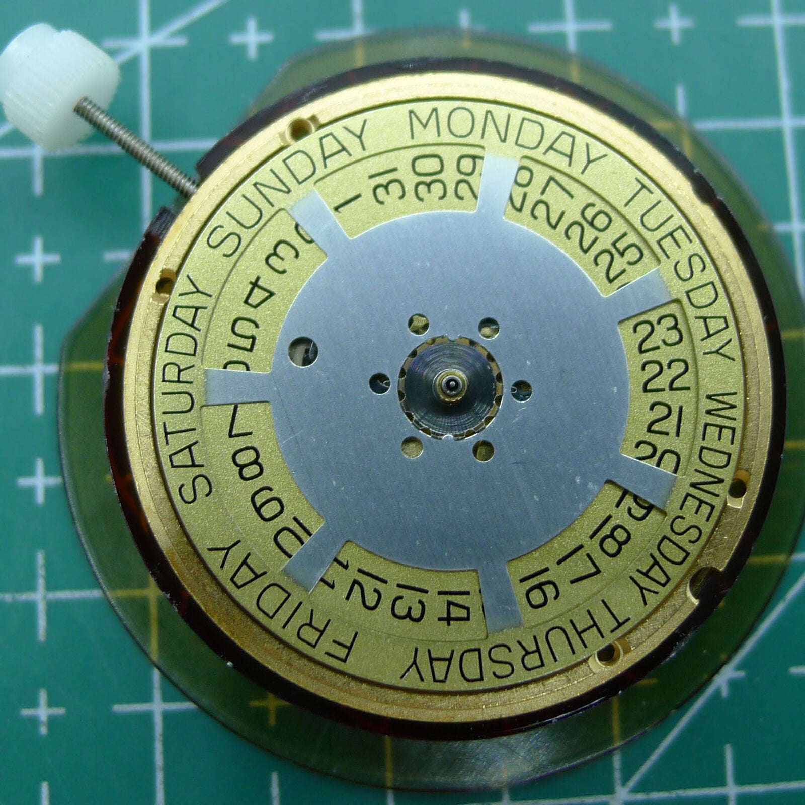 Swiss Made ETA 955.132 quartz watch movement displaying double calendar with week at 12 and date at 3 features.