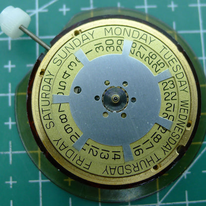 Swiss Made ETA 955.132 quartz watch movement displaying double calendar with week at 12 and date at 3 features.