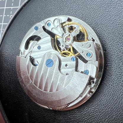 Small silver hollow watch movement with double mainspring and balance wheel at 6 o?clock by Kleines brand.