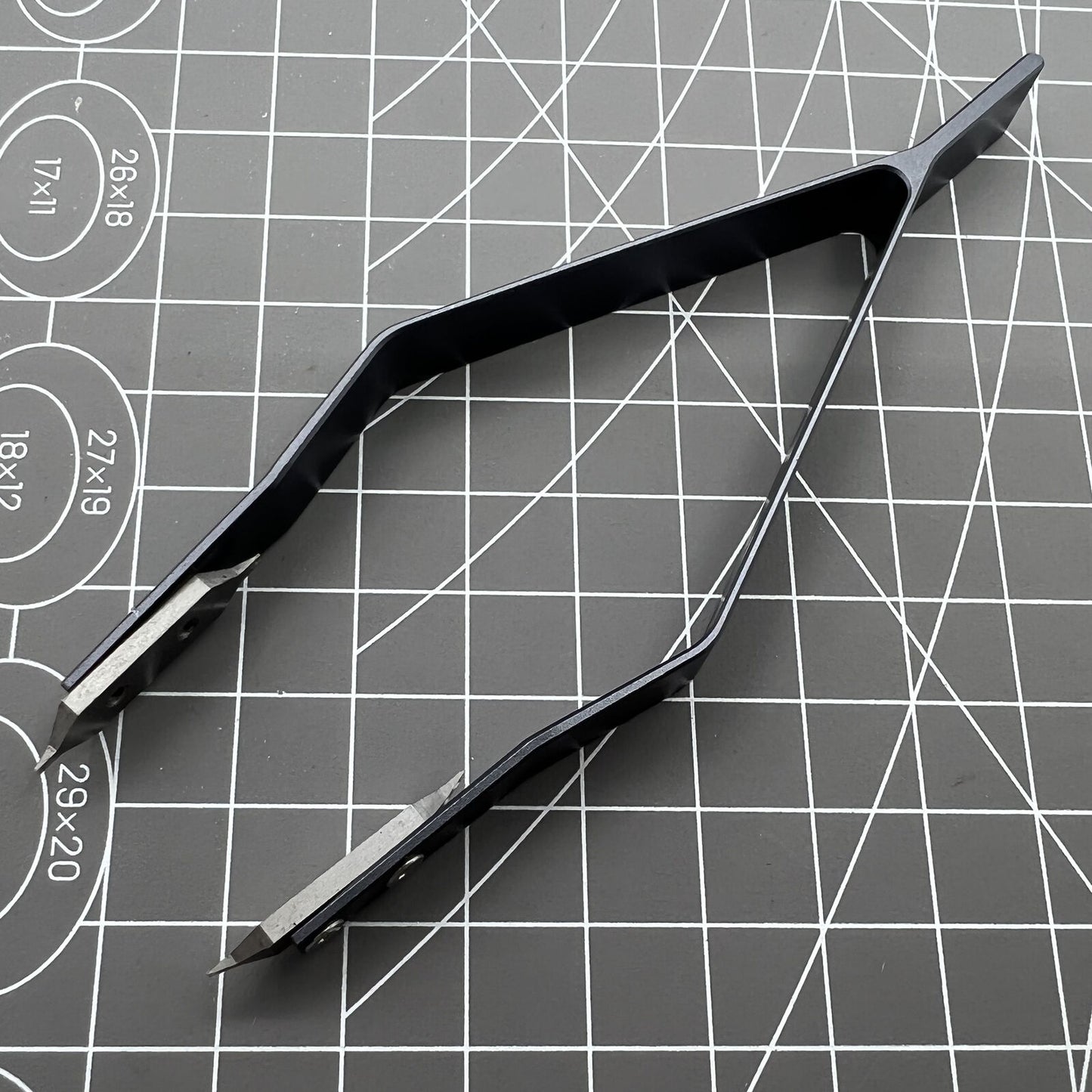Stainless steel spring bar tweezer by 7825 for precise lug removal and watch strap fitting.