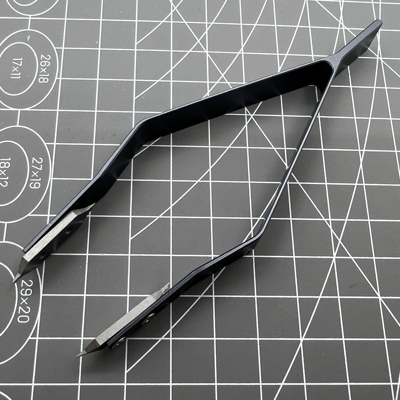 Stainless steel spring bar tweezer by 7825 for precise lug removal and watch strap fitting.