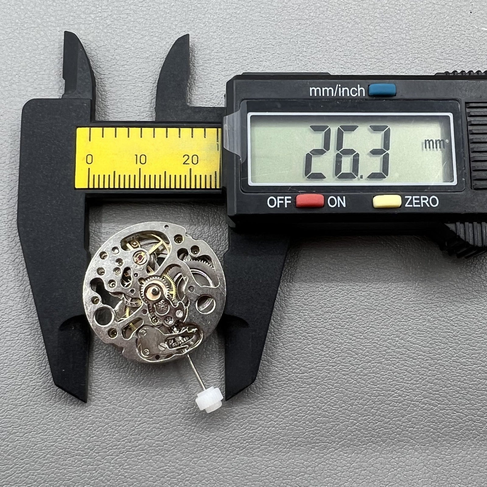 Hollow silver automatic watch movement revealing detailed mechanical gears and precision engineering.