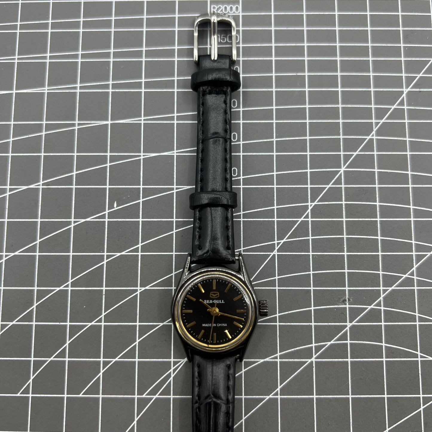 27mm Tianjin Seagull ladies watch with manual mechanical movement and golden nail hour markers.