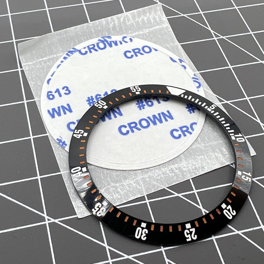 38mm black ceramic watch bezel insert with orange graduation for precise time tracking, compatible with various watch models.