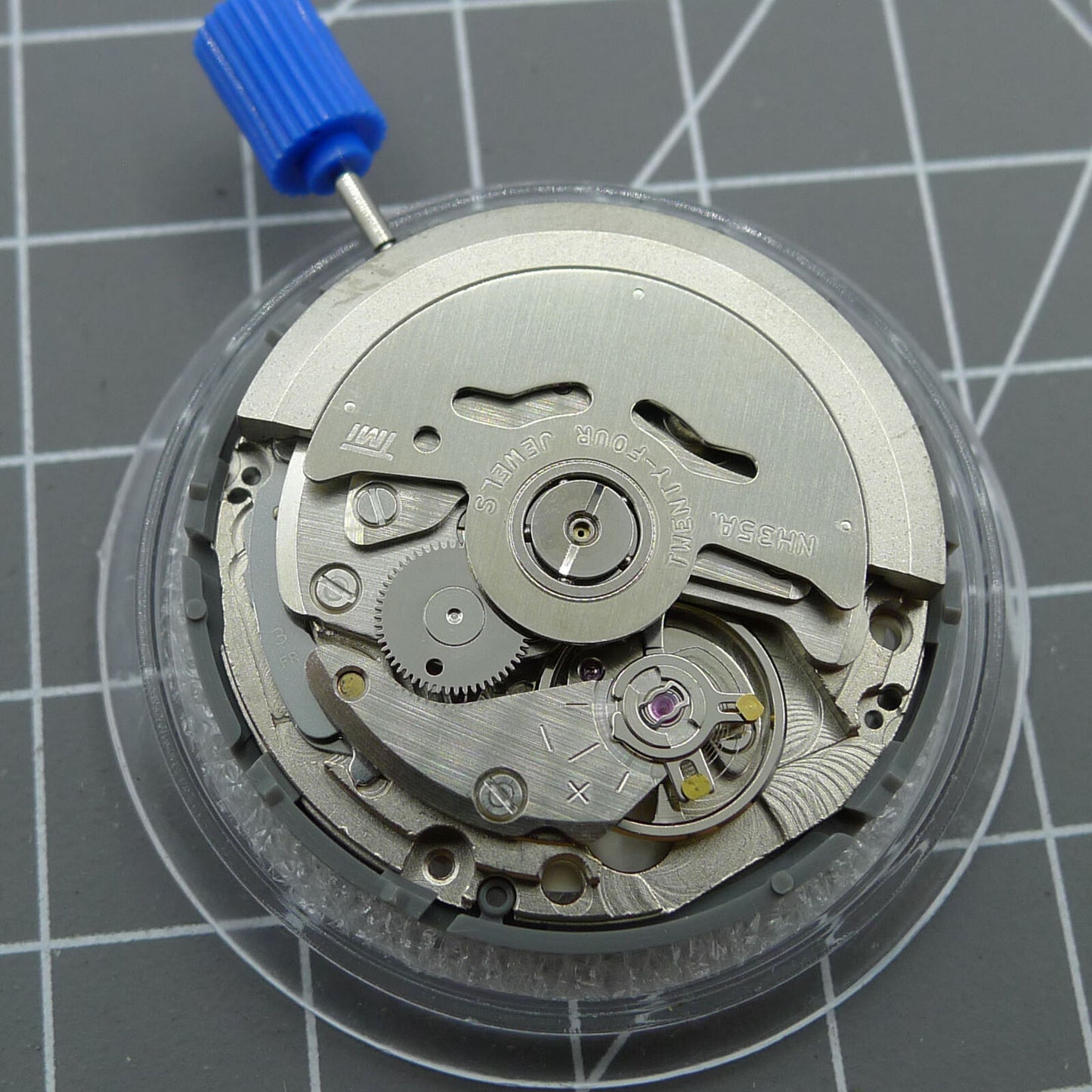Japan NH35A automatic watch movement featuring black spade hands and SKX007 style crown at 3 o'clock for precise timekeeping.