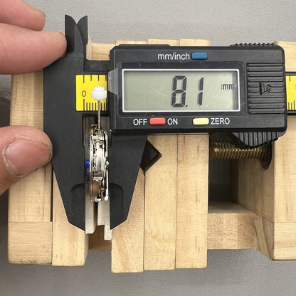 China Made 8205 automatic watch movement showing small seconds subdials at 3, 6, and 9 o'clock positions.