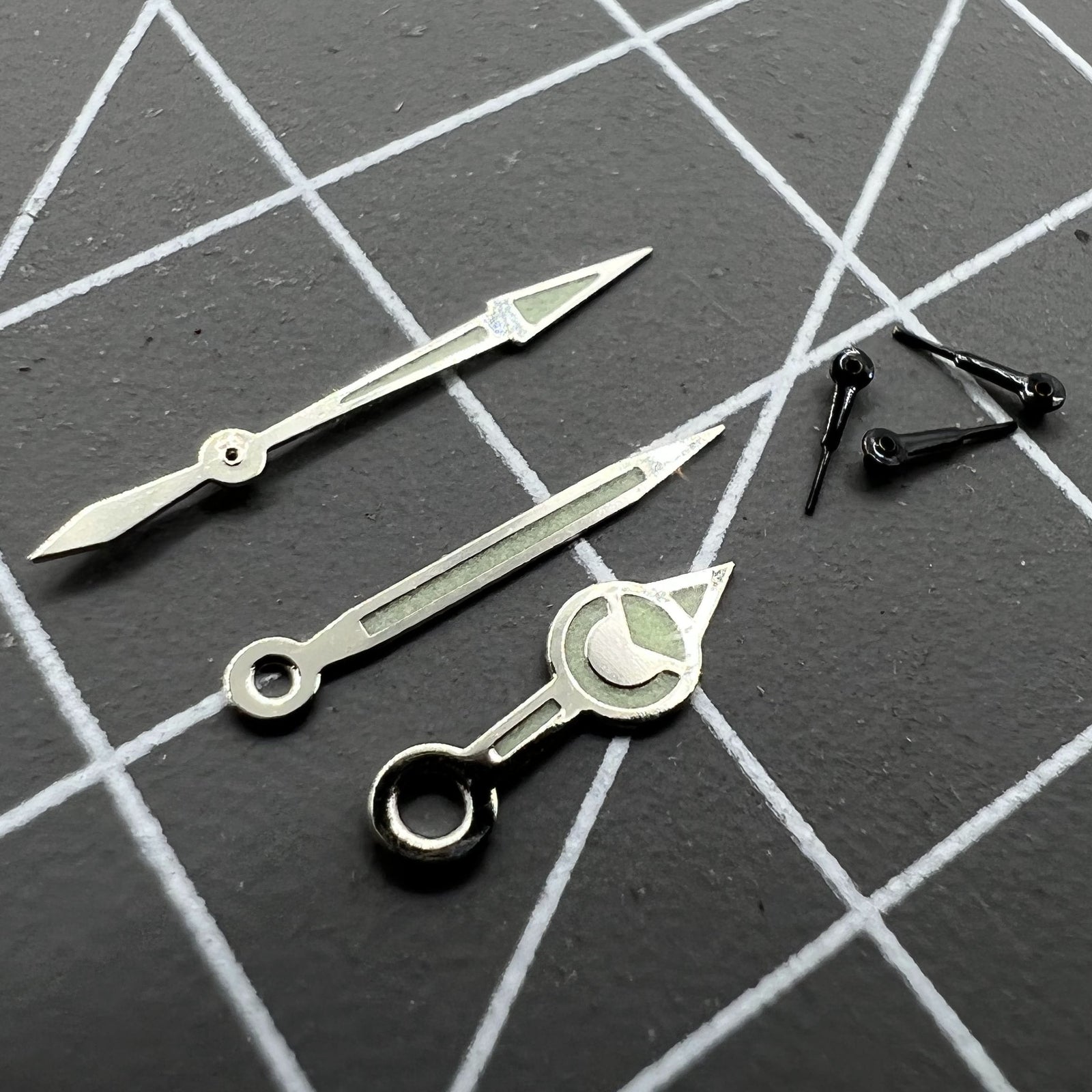 Black 12mm watch hands with silver trim and green luminous finish for Miyota 0S60 movement.