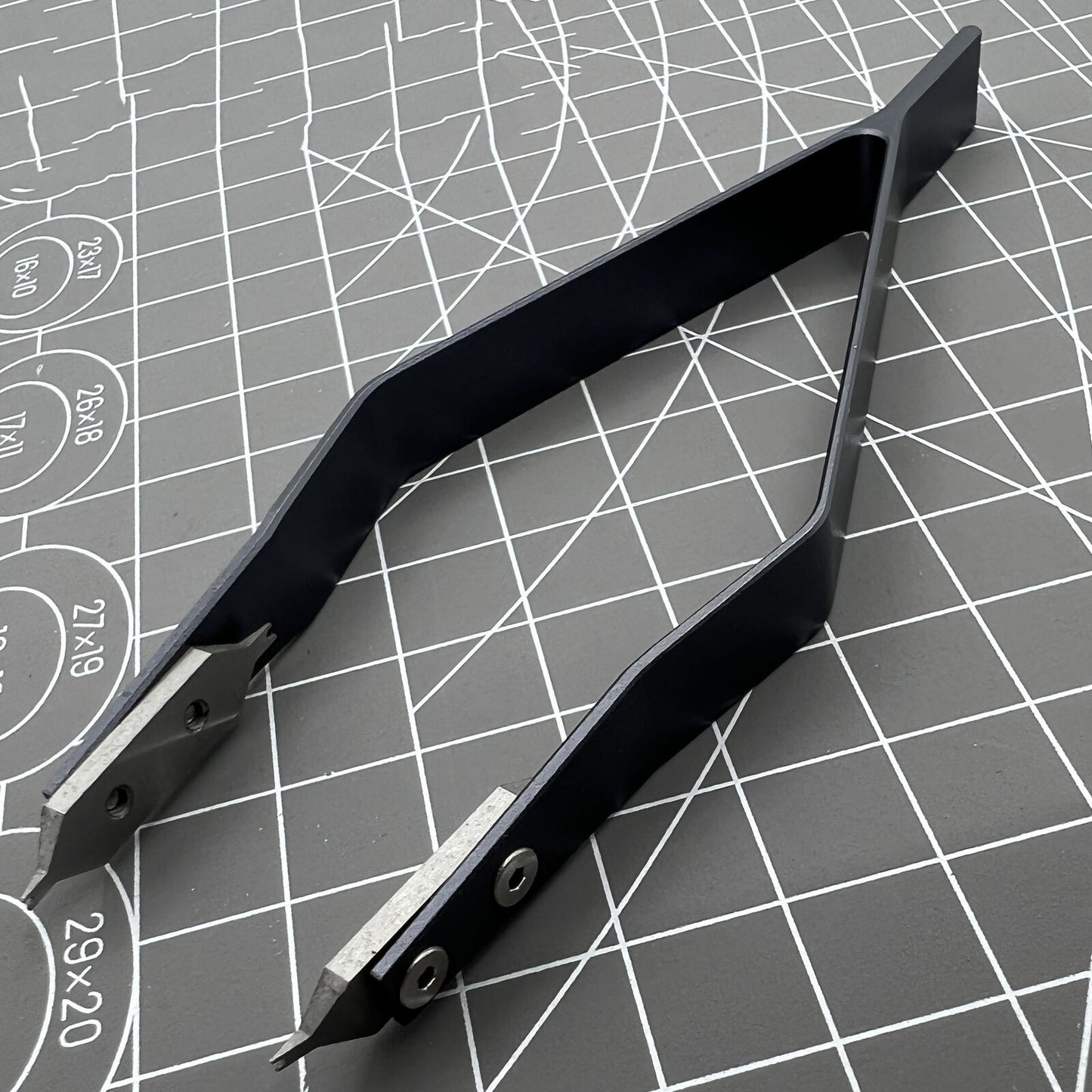Stainless steel spring bar tweezer by 7825 for precise lug removal and watch strap fitting.
