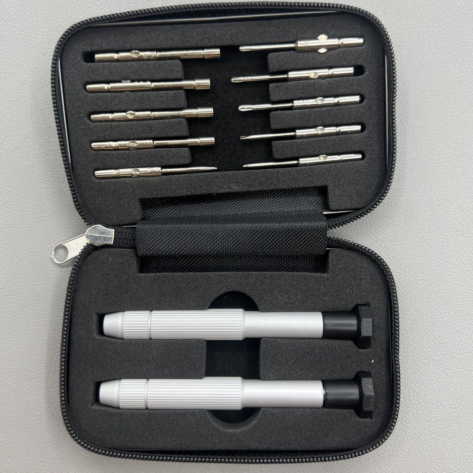 Precision screwdriver set for watch and eyeglass repair, includes hex tools and cutter heads with grip handle.