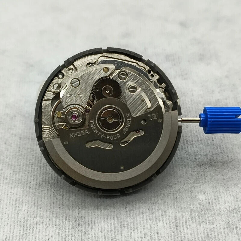 NH35 automatic watch movement with black dial, vibrant orange numerals, date display, and side crown.