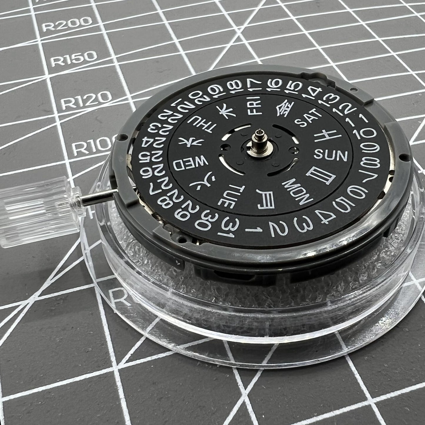 Miyota NH36A automatic movement with black finish and blue lume, showing crown at 3/3.8 position for precise timekeeping.