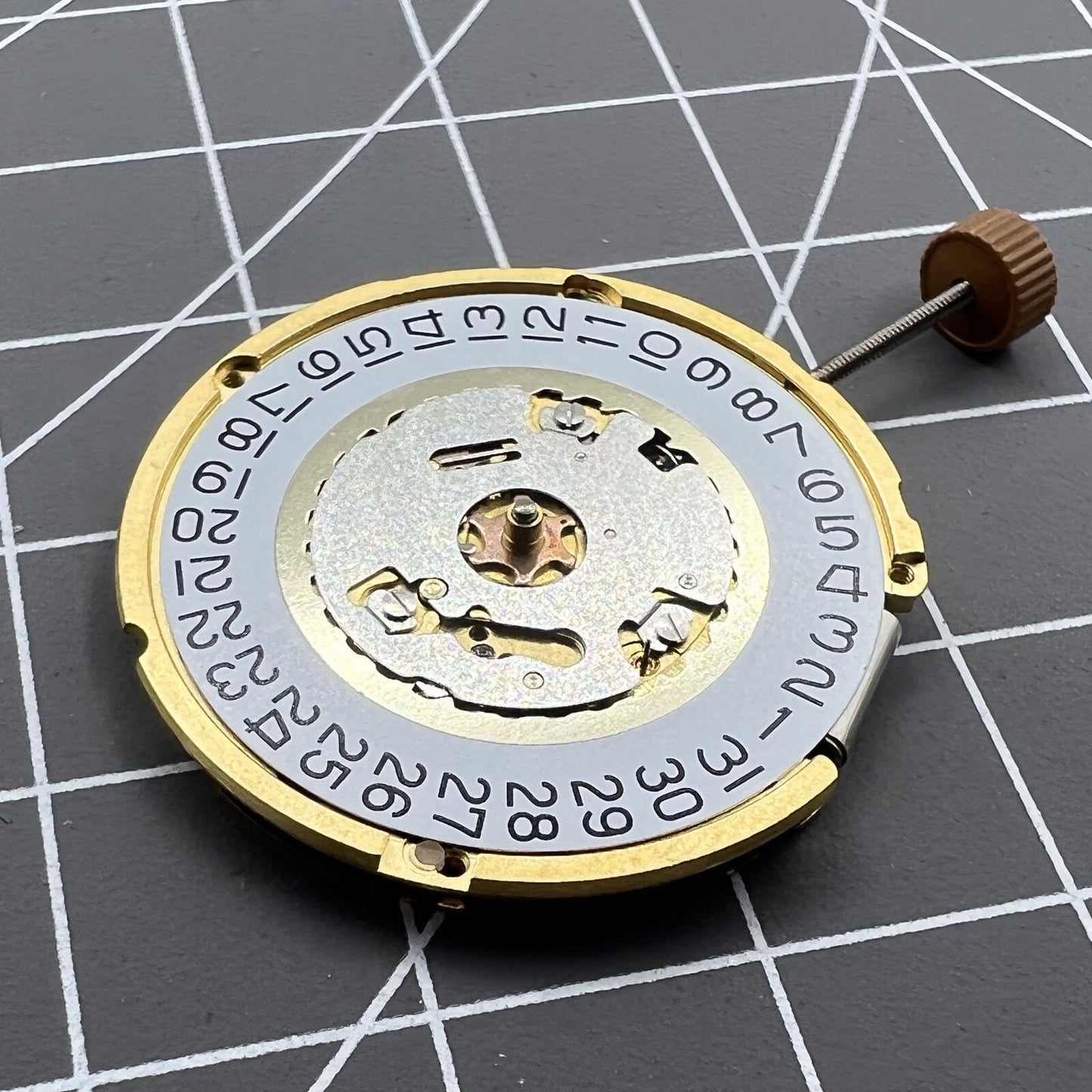 Swiss Made Ronda 6004D quartz watch movement with date display at 3 o?clock, precision timing accessory.