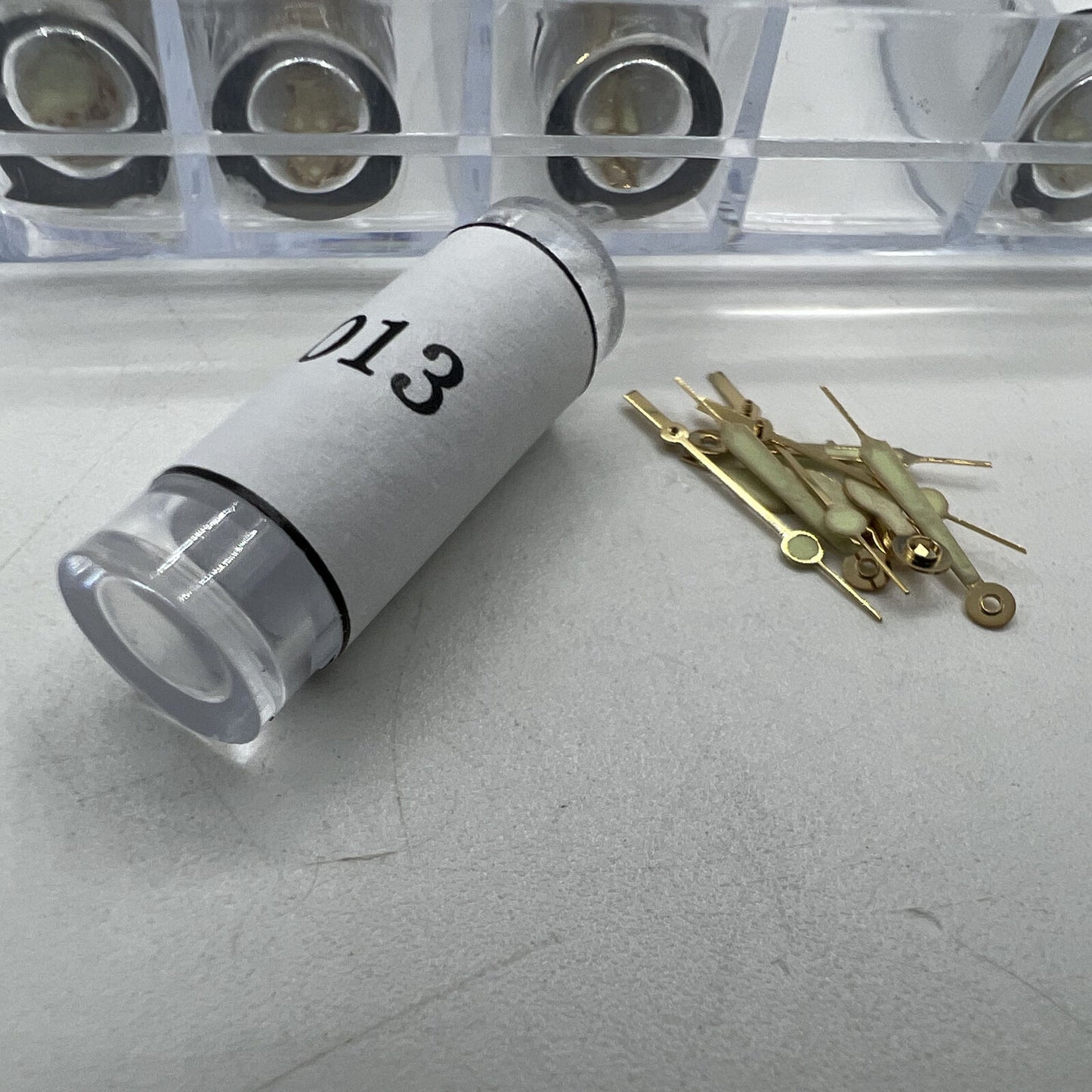 Golden luminous hour and minute watch hands by Watch Parts, 51-piece set for precise time display in watch repairs.