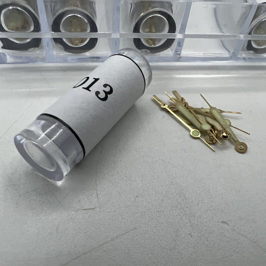 Golden luminous hour and minute watch hands by Watch Parts, 51-piece set for precise time display in watch repairs.