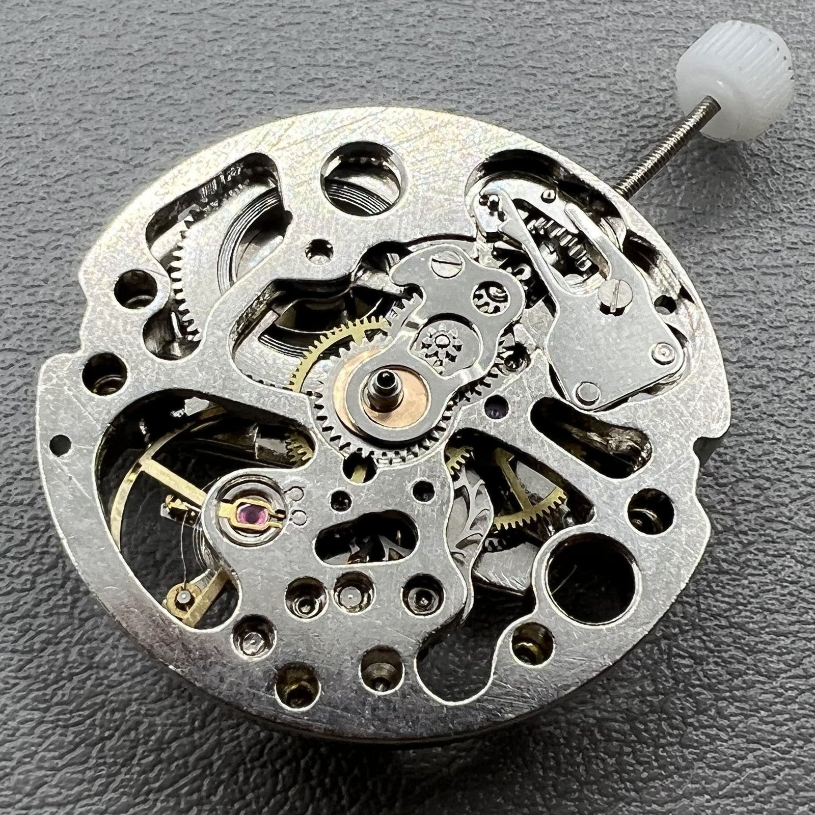 7120 Hollow silver automatic watch movement showcasing intricate mechanical gears and craftsmanship.