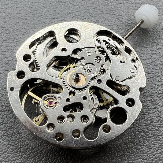 7120 Hollow silver automatic watch movement showcasing intricate mechanical gears and craftsmanship.