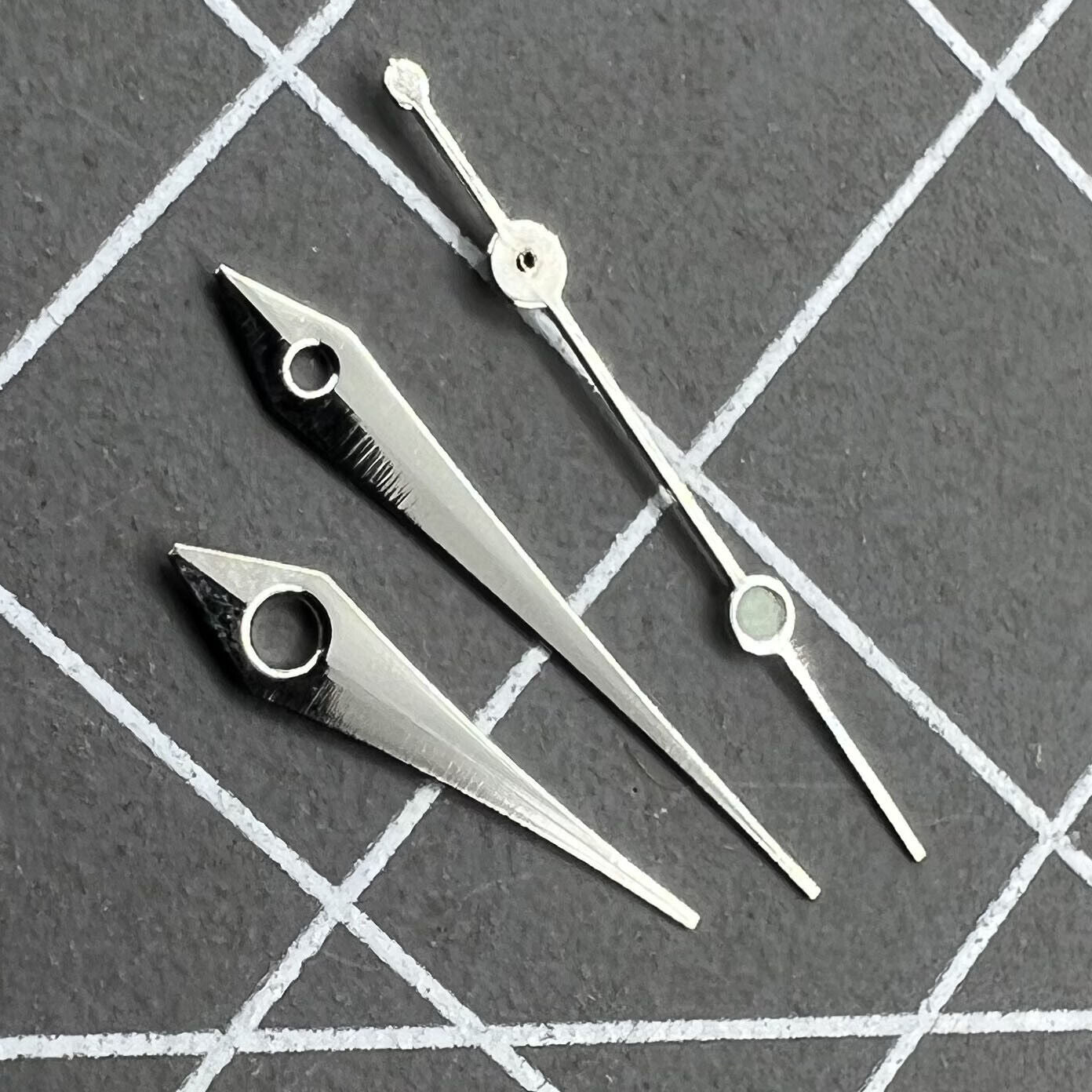 Silver 13mm arrow-shaped watch hands set by Trim, designed for Ronda 515 quartz movement timepieces.
