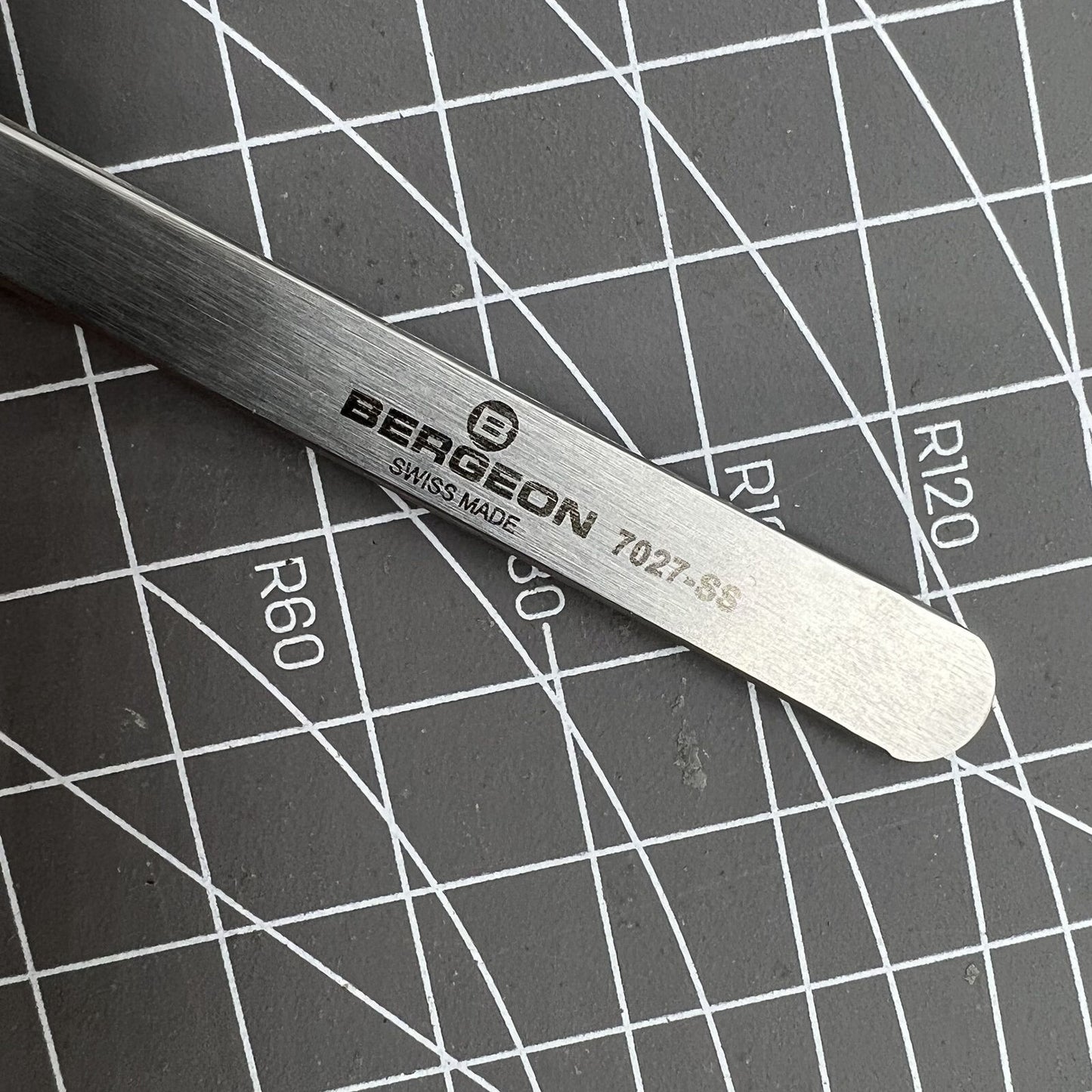 Bergeon 7027-SS precision tweezer with narrow stainless steel tips for detailed Swiss watch repairs.