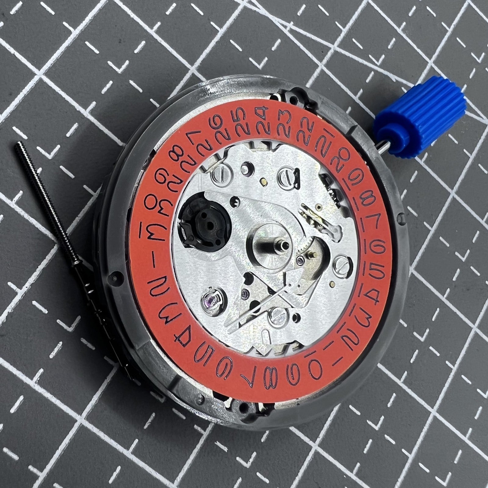 Seiko NH35 automatic watch movement with high precision and vibrant orange dial, ideal for watch repairs.