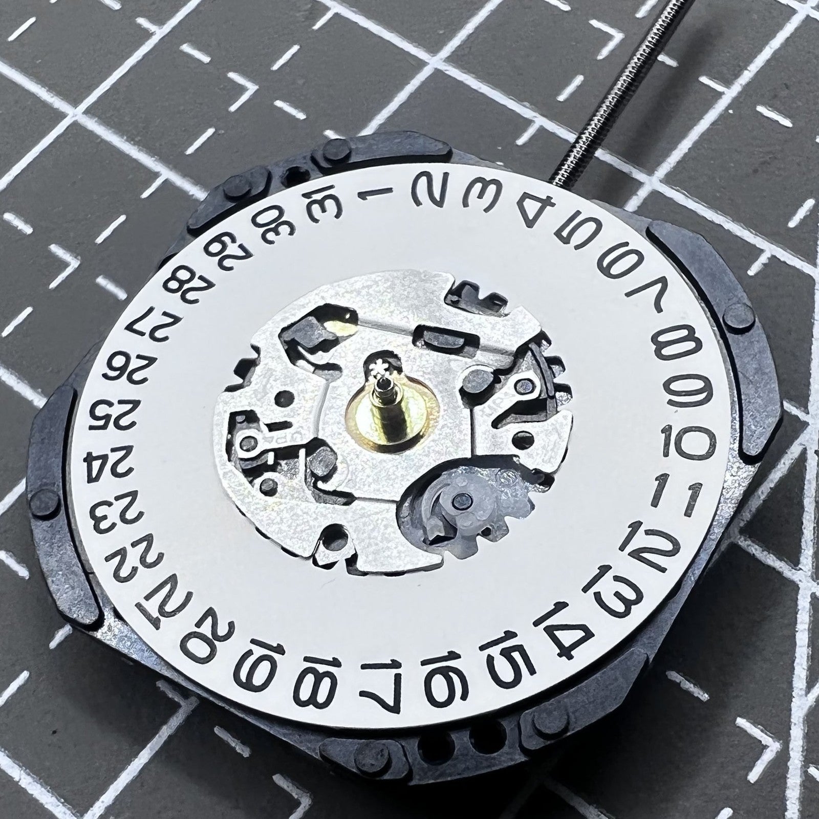 Seiko 7N32C Quartz watch movement showing three hands and single date at 3 o'clock for watch accessories.