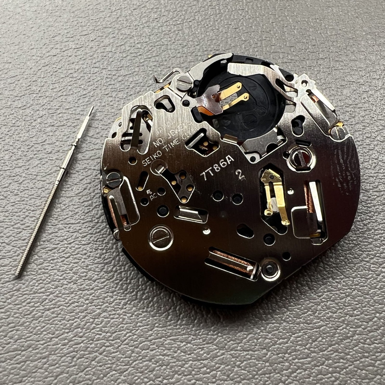 Seiko 7T86A quartz watch movement replacement part, precision Japanese craftsmanship for repairs.