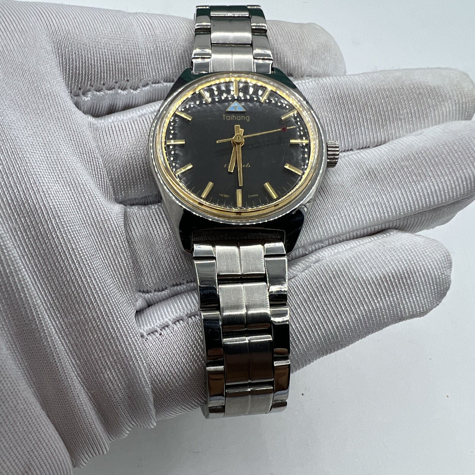 32mm Chinese Taihang manual watch with black dial, golden markers, and 17-jewel precision movement detail