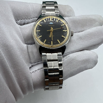 32mm Chinese Taihang manual watch with black dial, golden markers, and 17-jewel precision movement detail