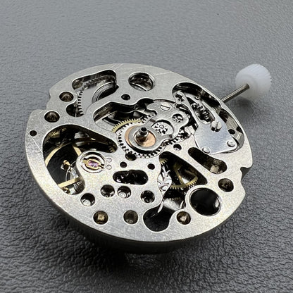 7120 Hollow silver automatic watch movement displaying intricate mechanical gears and expert craftsmanship.