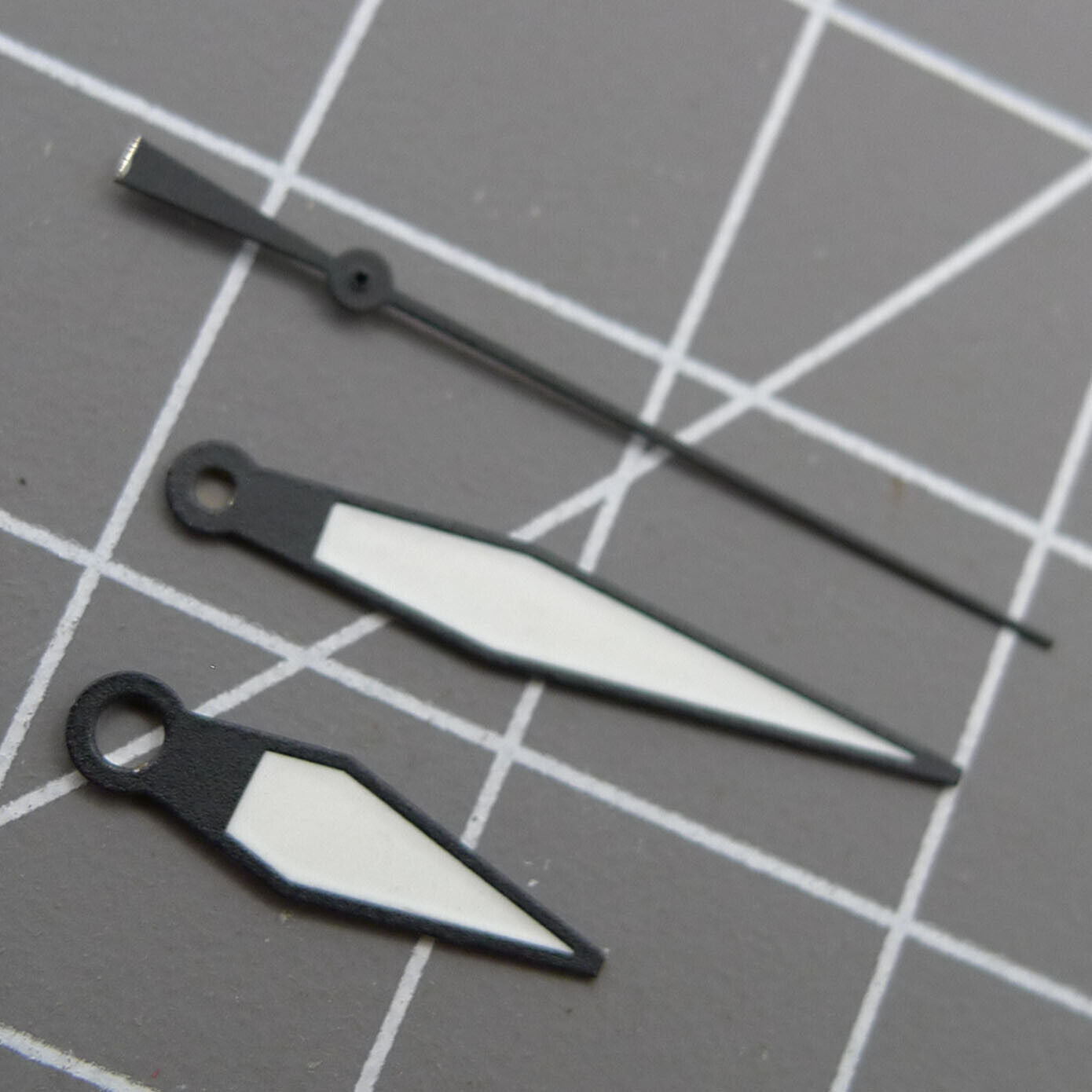 White diamond-shaped orange lume watch hands designed for ETA2836/2846/2824/2846 movements by White+diamond.