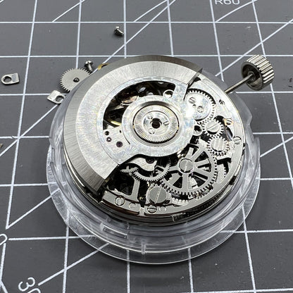 Tianjin Seagull ST25 silver automatic watch movement with hollow design and three hands.