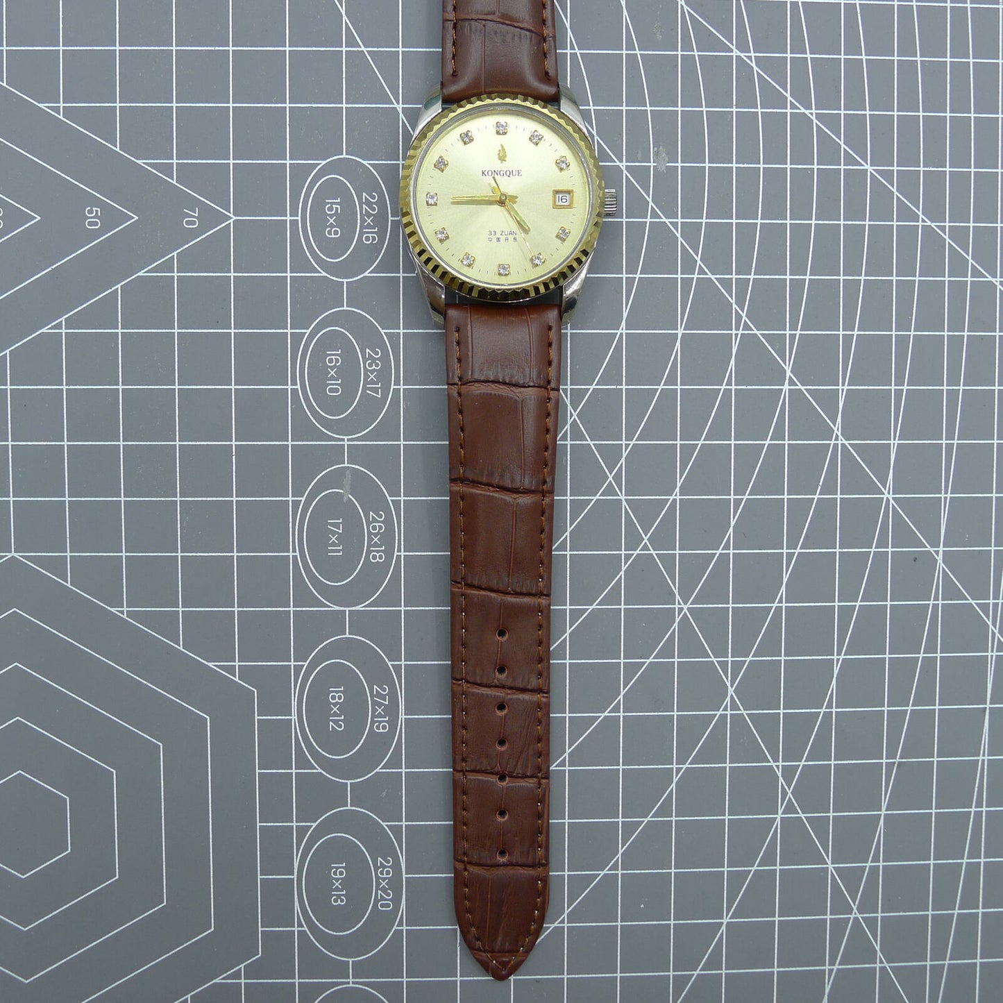 Dandong Peacock 37mm manual watch with golden dial, single calendar, 33 jewels, elegant style.