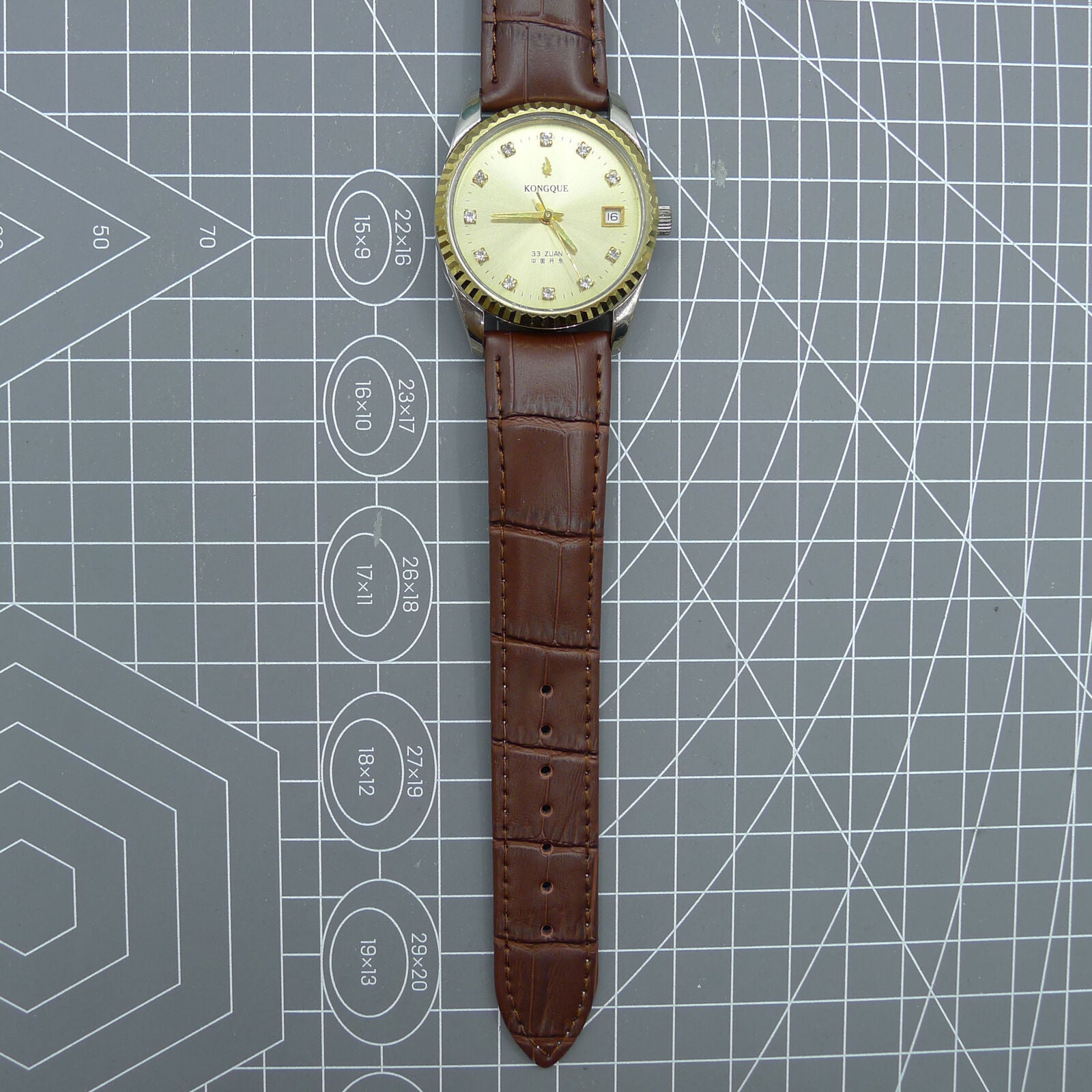 Dandong Peacock 37mm manual watch with golden dial, single calendar, 33 jewels, elegant style.