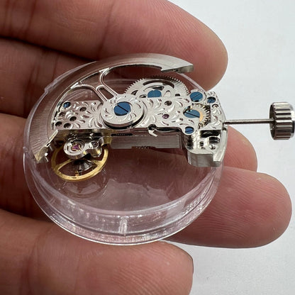 Silver long pendulum wheel watch accessory by Asian with detailed automatic mechanical movement design for precision timekeeping.
