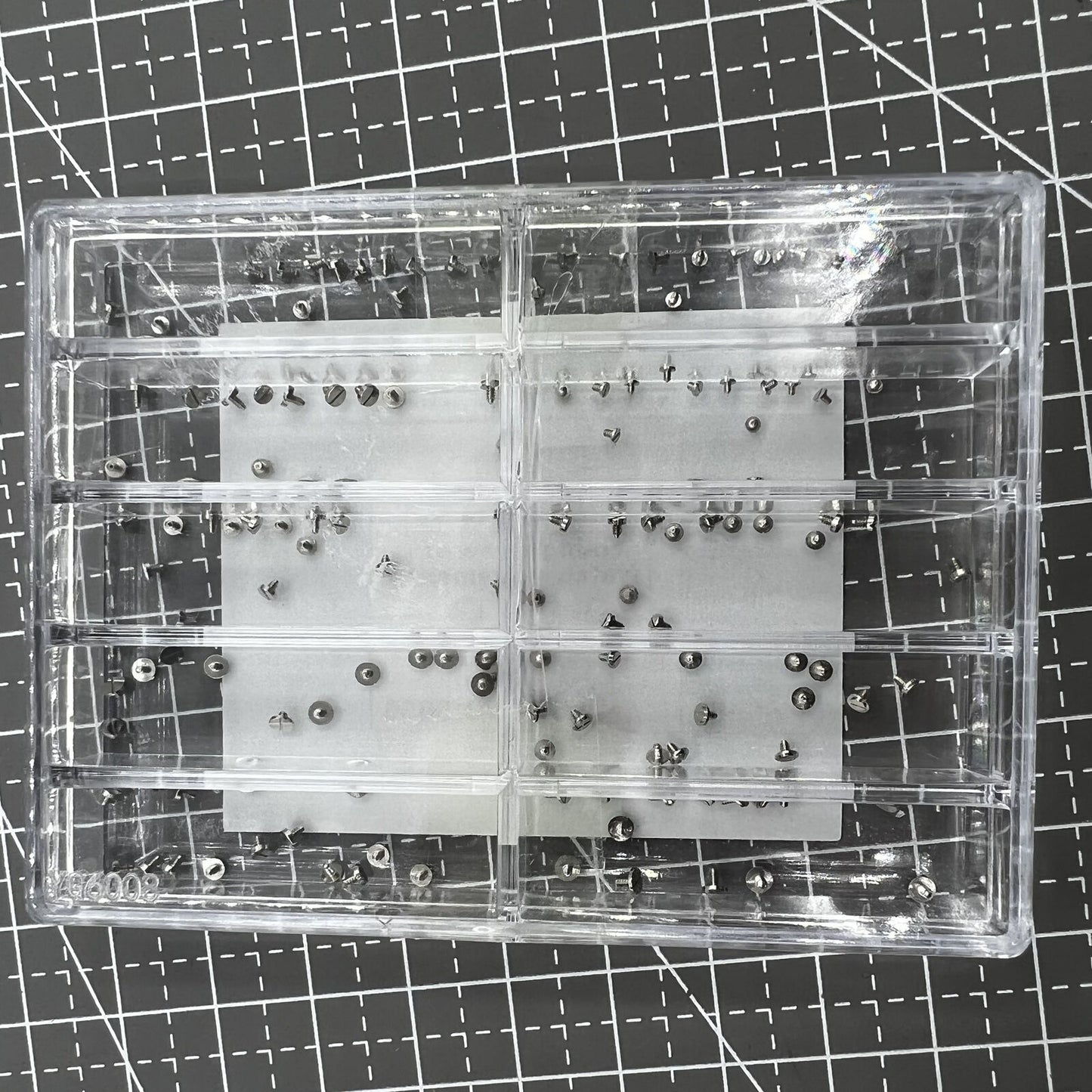 Assortment of watch movement fixing screws in various sizes for precise repairs and adjustments.
