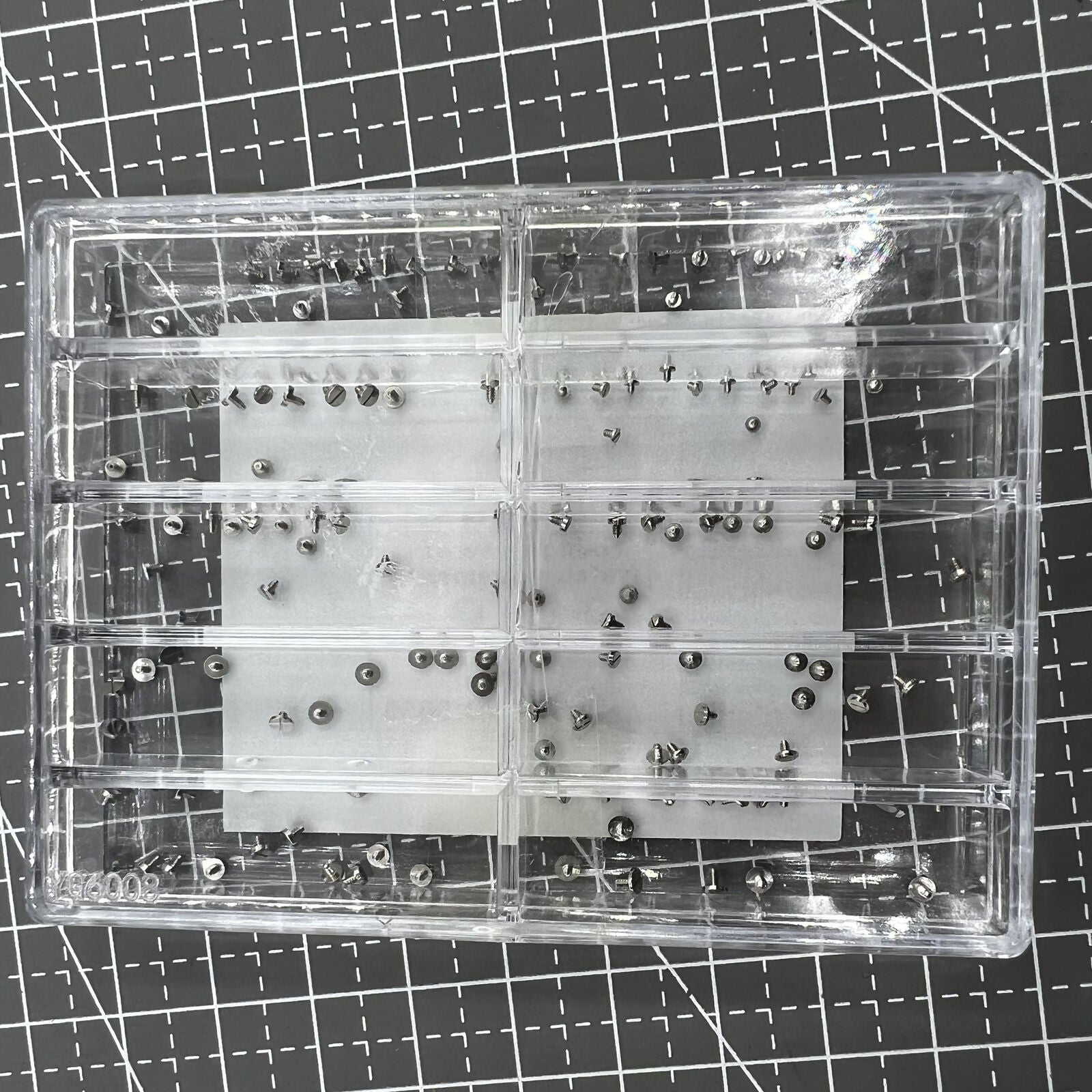 Assortment of watch movement fixing screws in various sizes for precise repairs and adjustments.