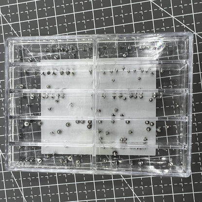 Assortment of watch movement fixing screws in various sizes for precise repairs and adjustments.