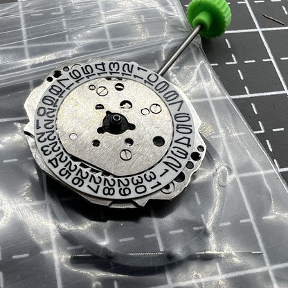 Miyota 4T13 quartz watch movement showing 3 hands and date window at 3 o'clock slot for precise timekeeping.