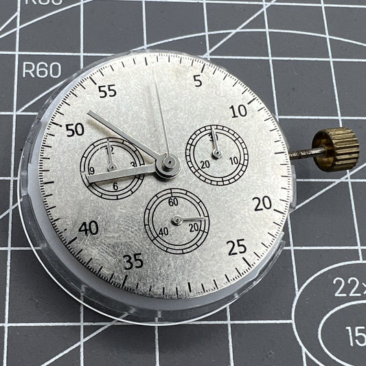 Close-up of China Made 7750 automatic chronograph movement with ETA 7753 configuration showing subdials at 3, 6, and 9 o'clock.