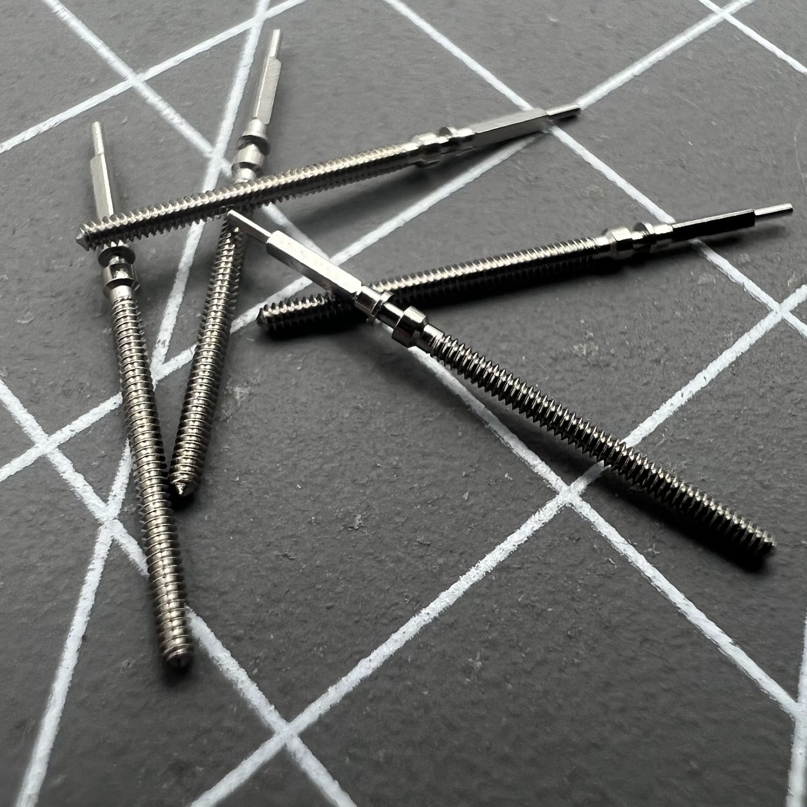 Set of 2 Omega winding stems for 560-565 movements, perfect for precise watch repairs and maintenance.