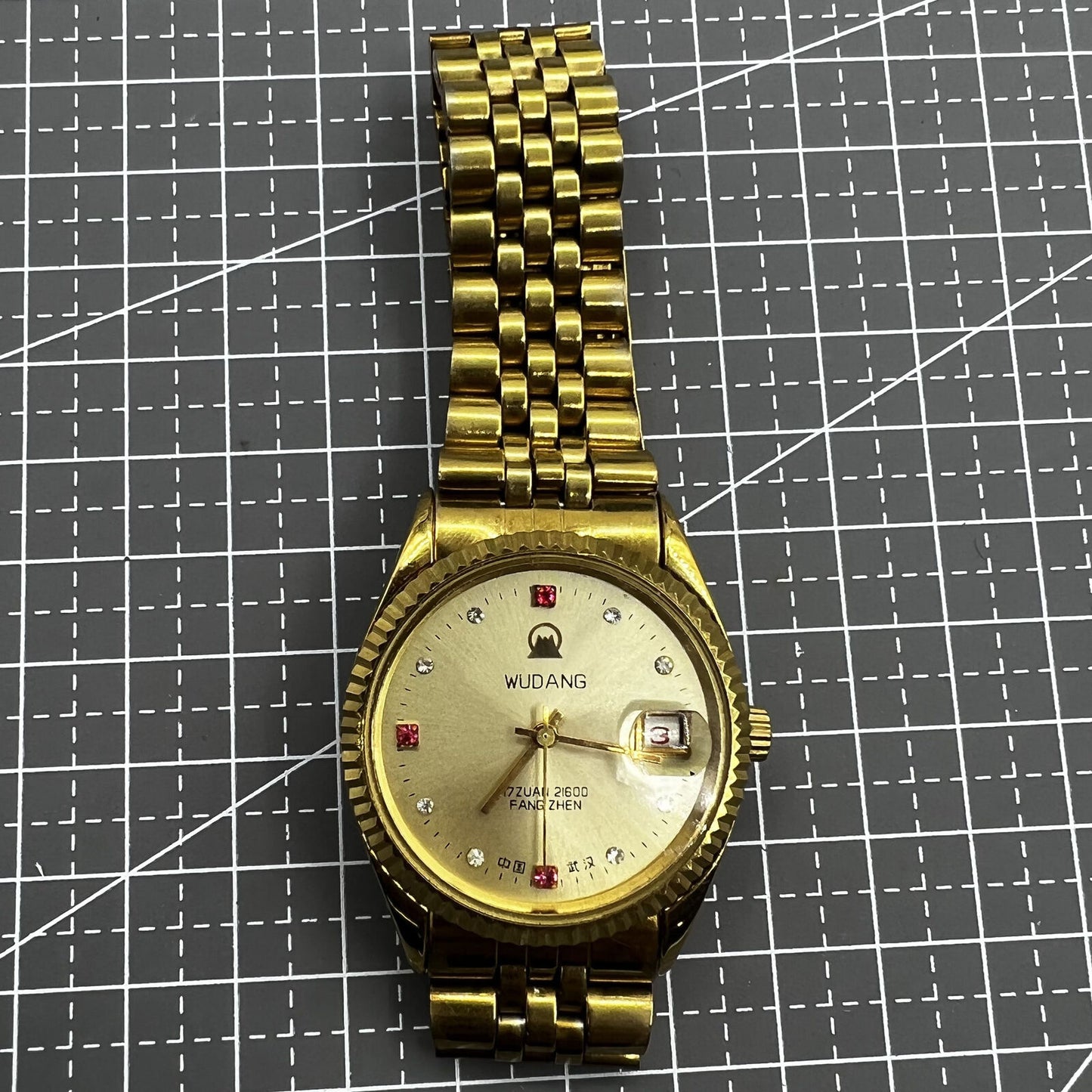 38mm Wudang Steel mechanical watch with golden dial and single calendar, 17 jewels, elegant design.